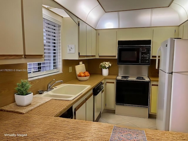 kitchen featuring white appliances, light tile patterned floors, light countertops, and a sink