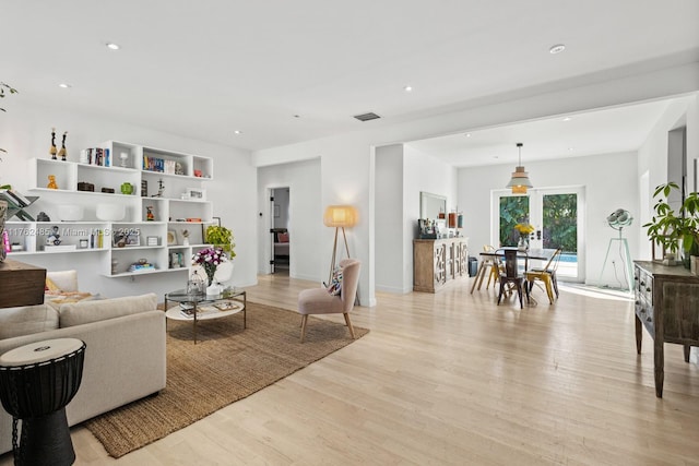 living area featuring recessed lighting, visible vents, and light wood-style floors