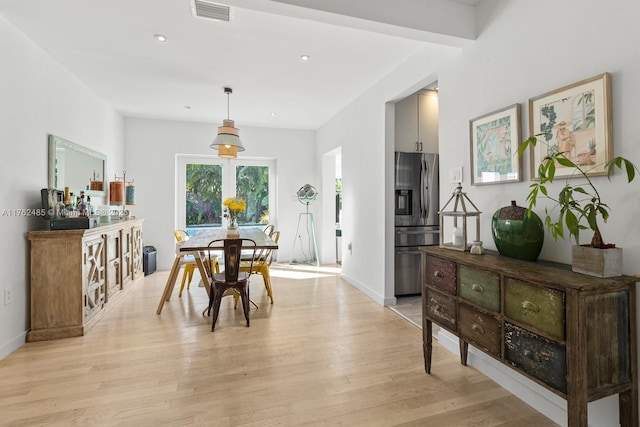 dining room with light wood-style flooring, recessed lighting, baseboards, and visible vents