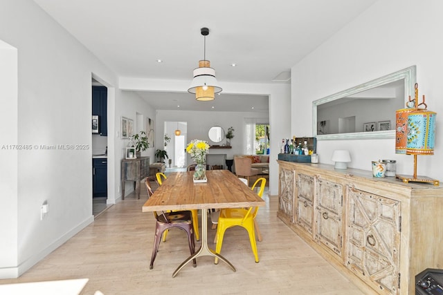 dining room featuring recessed lighting, light wood-style flooring, and baseboards