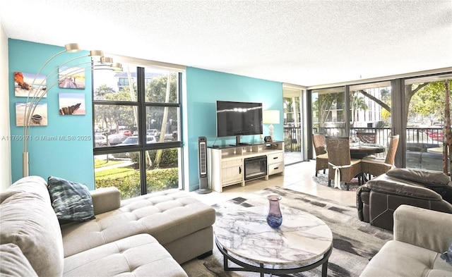 tiled living room with a wall of windows and a textured ceiling