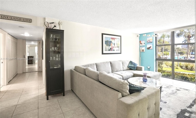 living area with light tile patterned flooring and a textured ceiling