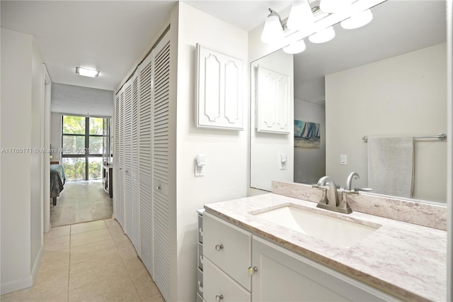 bathroom with tile patterned flooring, vanity, and a closet