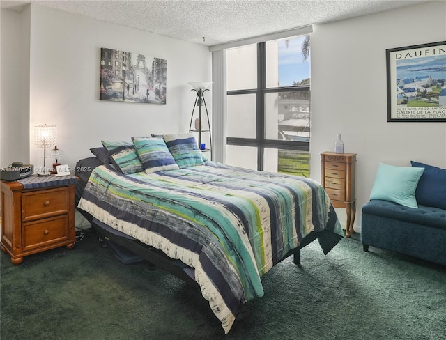 bedroom with a textured ceiling and dark carpet