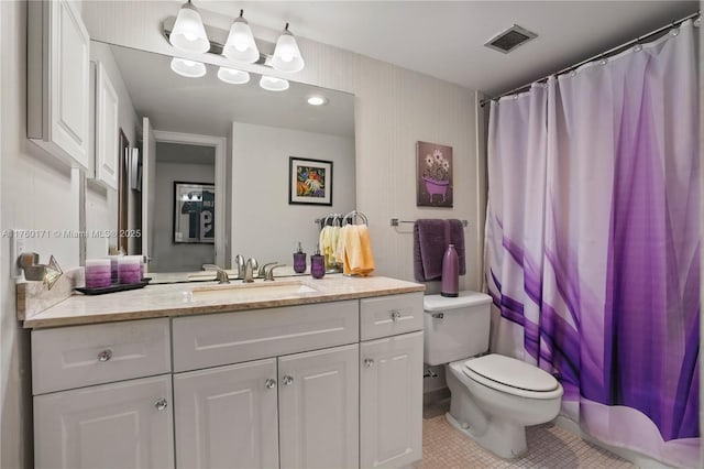 bathroom featuring vanity, tile patterned floors, toilet, and visible vents