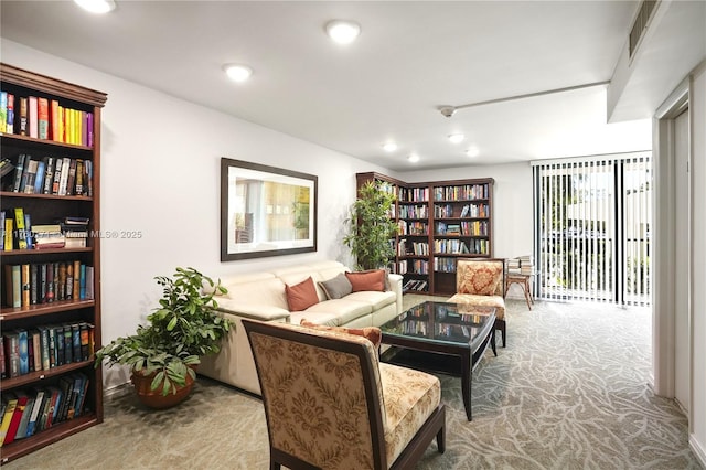 sitting room featuring visible vents, recessed lighting, and carpet