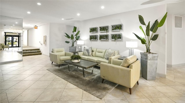 living area with light tile patterned floors, visible vents, recessed lighting, and baseboards