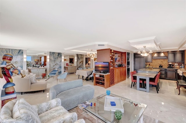 living room with crown molding, a notable chandelier, and visible vents