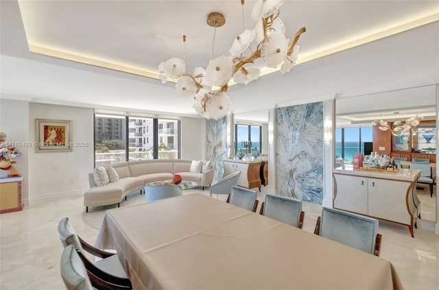 dining area with baseboards and a raised ceiling