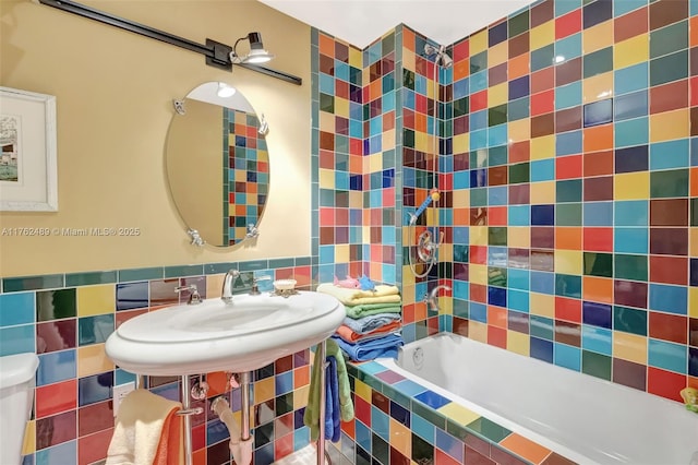 bathroom with tile walls and toilet