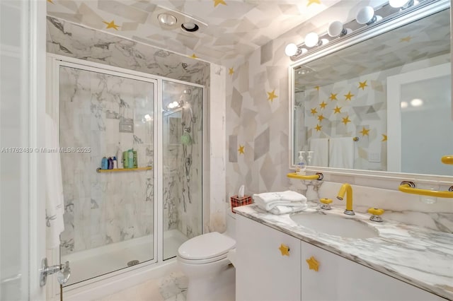 full bath featuring vanity, toilet, and a marble finish shower