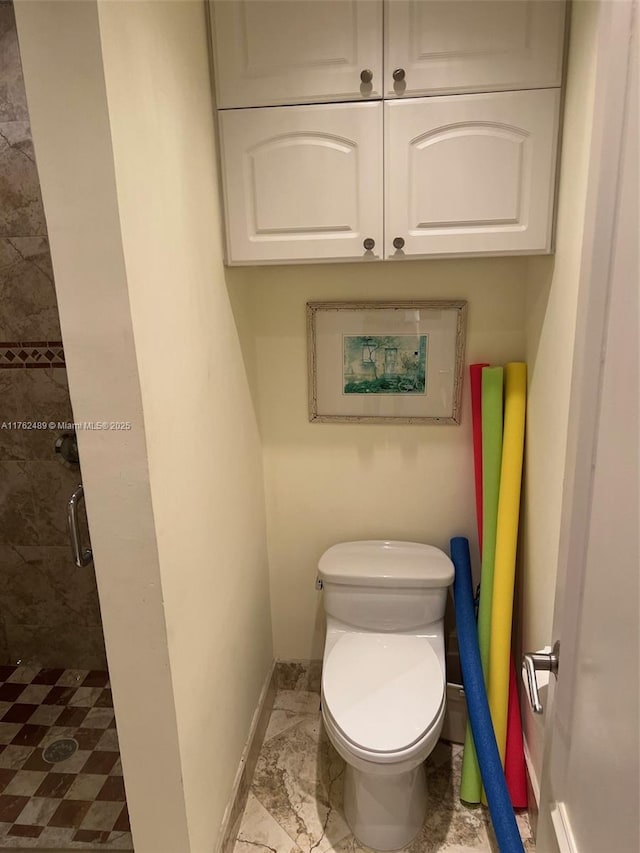 full bathroom featuring a shower stall, toilet, baseboards, and marble finish floor