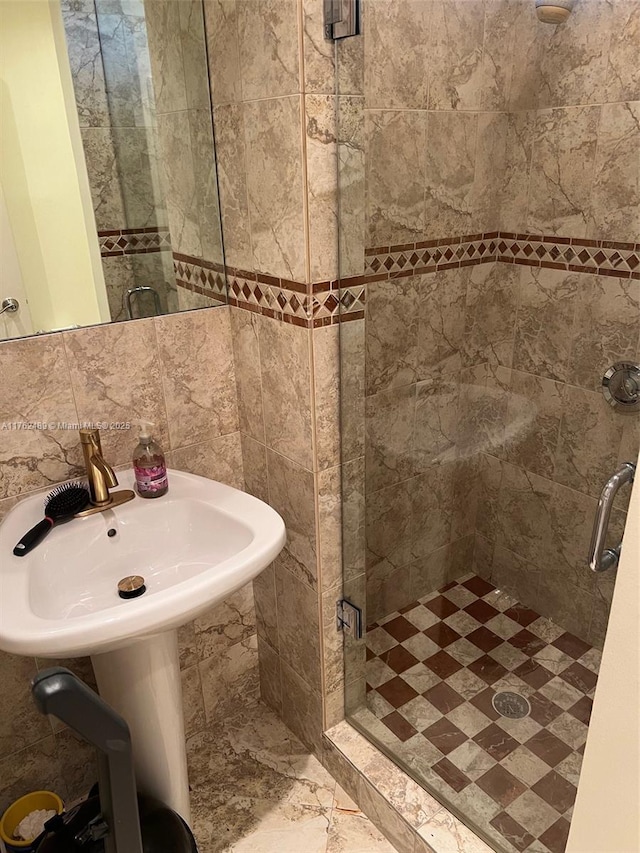 bathroom with backsplash and a stall shower