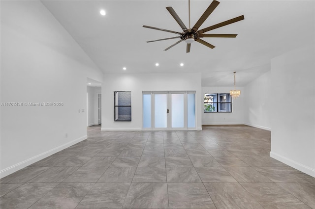 unfurnished living room with recessed lighting, ceiling fan with notable chandelier, high vaulted ceiling, and baseboards