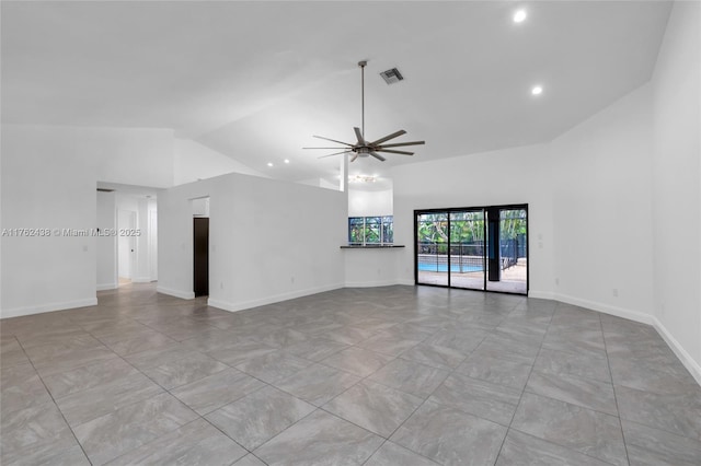 empty room featuring a ceiling fan, visible vents, and high vaulted ceiling