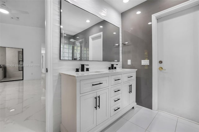 full bath featuring a sink, double vanity, recessed lighting, and a ceiling fan