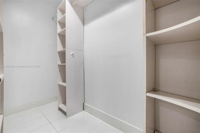 spacious closet featuring tile patterned flooring