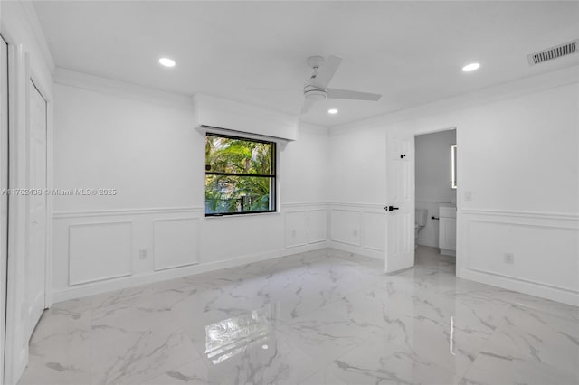 spare room featuring visible vents, recessed lighting, ceiling fan, ornamental molding, and marble finish floor