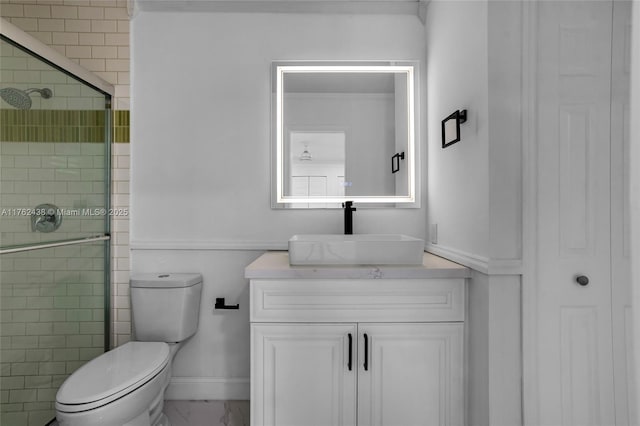 full bath featuring toilet, marble finish floor, a shower stall, baseboards, and vanity