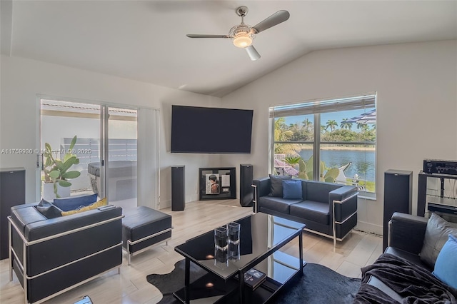 living area with light wood-style flooring, lofted ceiling, and ceiling fan