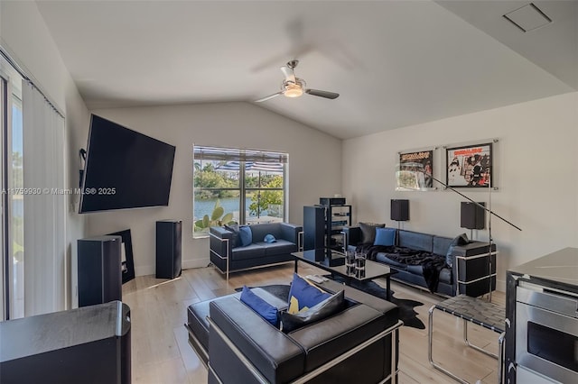 living room featuring ceiling fan, baseboards, light wood-style flooring, and vaulted ceiling