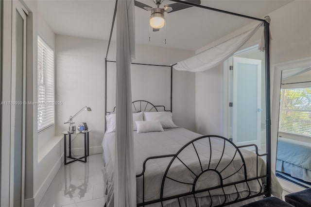 bedroom with baseboards, marble finish floor, and a ceiling fan