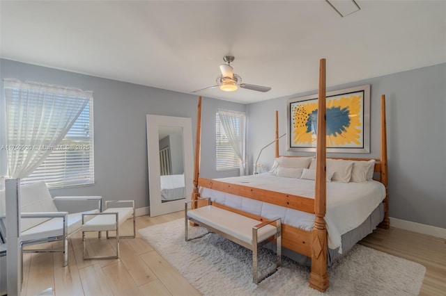 bedroom with wood finished floors, baseboards, and ceiling fan