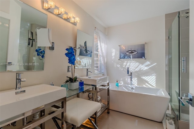 full bathroom with a soaking tub, a shower stall, and a sink