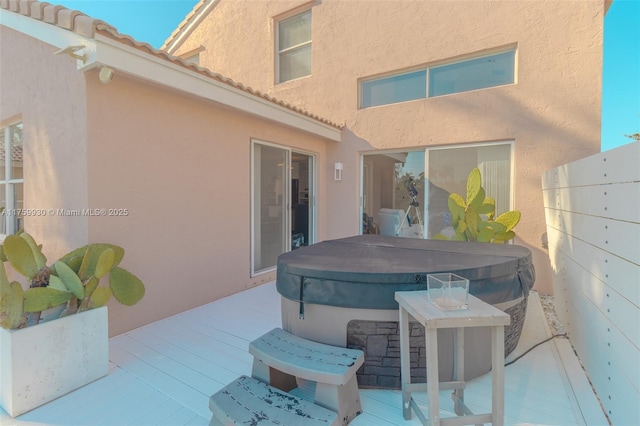 view of patio / terrace featuring a wooden deck and a hot tub