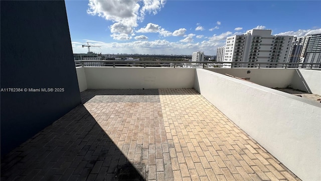 view of patio featuring a view of city and a balcony