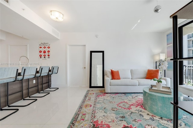 tiled living area featuring plenty of natural light and baseboards