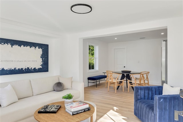 living area featuring recessed lighting, light wood-style flooring, and visible vents