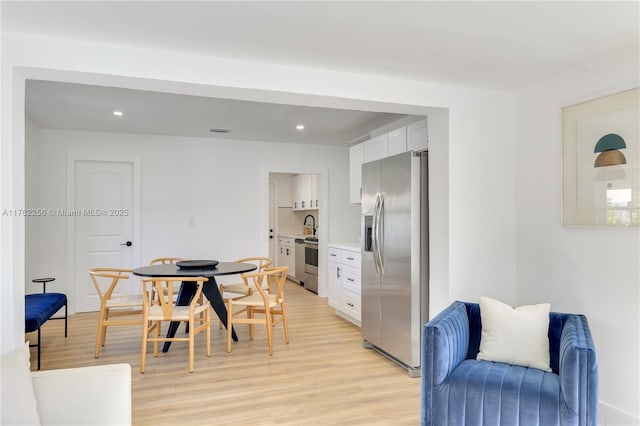 dining space featuring recessed lighting, visible vents, and light wood-style flooring