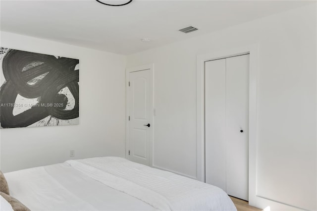 bedroom featuring visible vents and a closet