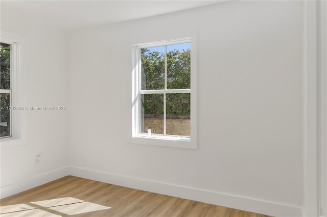 spare room with light wood-type flooring and baseboards