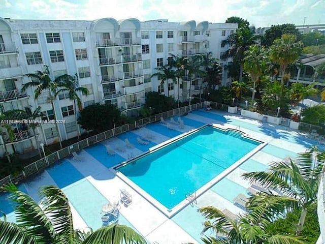 community pool featuring a patio area and fence
