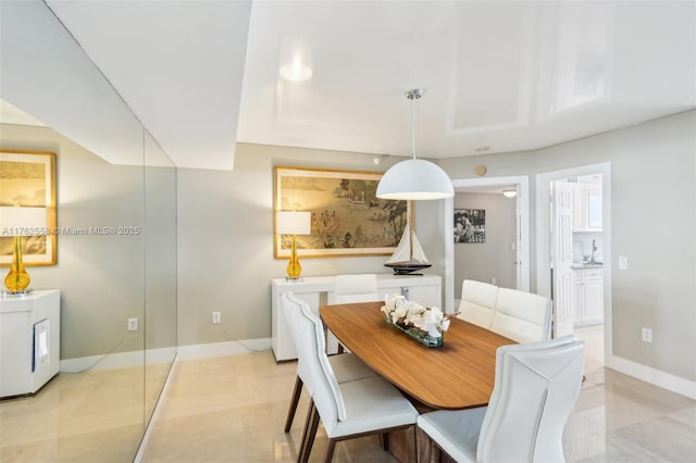 dining area with light tile patterned floors and baseboards