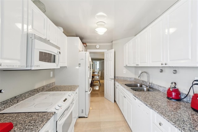 kitchen featuring a sink, white appliances, white cabinets, and light tile patterned floors