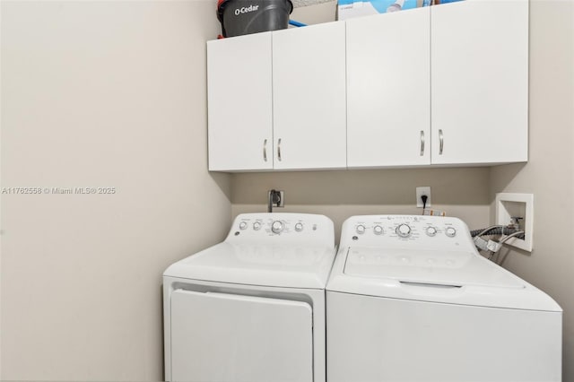 clothes washing area with cabinet space and independent washer and dryer