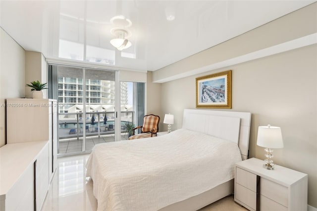 bedroom with access to outside and light tile patterned floors