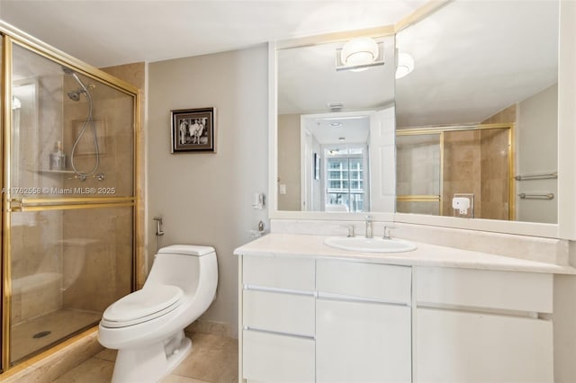 bathroom with vanity, tile patterned floors, toilet, and a stall shower