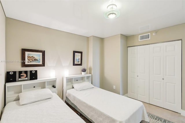 bedroom featuring a closet and visible vents