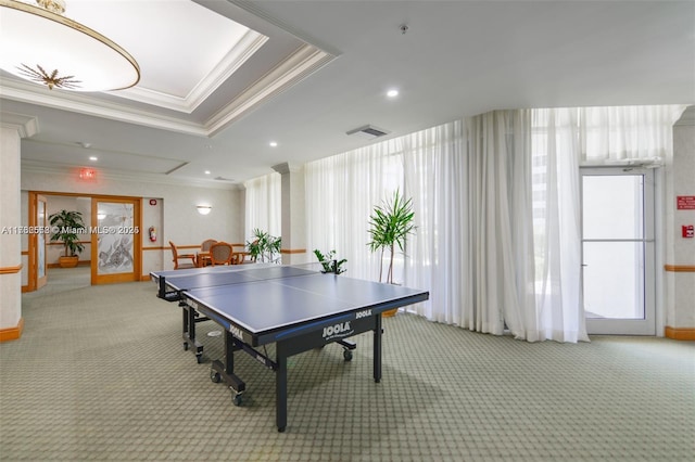 game room with a tray ceiling, recessed lighting, crown molding, and light carpet