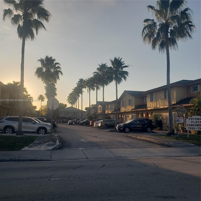 view of street with curbs, traffic signs, and sidewalks