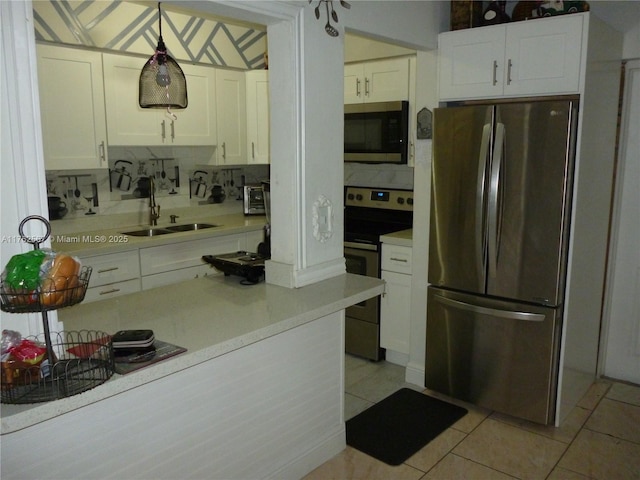 kitchen featuring a sink, stainless steel appliances, light countertops, white cabinets, and tasteful backsplash