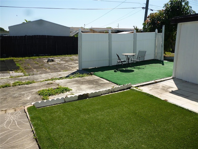 view of yard featuring a patio area and fence