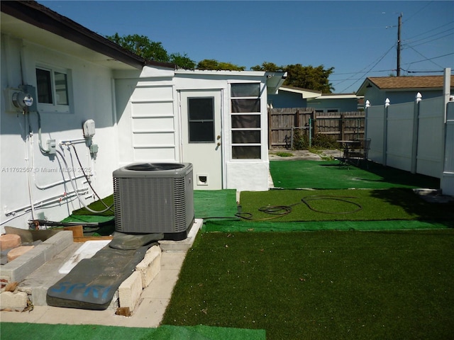 view of outbuilding with central air condition unit and fence