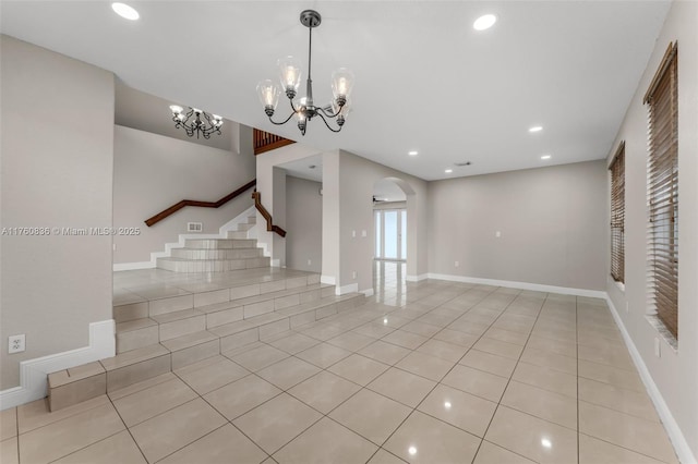 interior space with stairs, recessed lighting, a chandelier, arched walkways, and light tile patterned floors