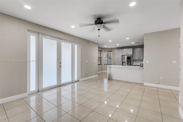 unfurnished living room with light tile patterned floors, recessed lighting, baseboards, and a ceiling fan