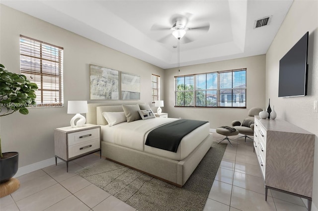 bedroom with light tile patterned floors, baseboards, multiple windows, and visible vents